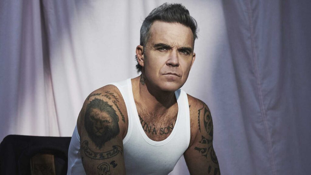 Robbie Williams sorprende en Sevilla al cantar su &eacute;xito m&aacute;s famoso junto a un m&uacute;sico callejero